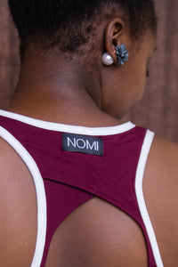 detail image of Burnt Henna Keyhole Tank from behind with a view of Nomi Network logo